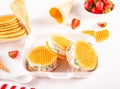 Homemade fresh vanilla strawberries ice cream sandwiches with waffles and waffle cones. Summer delicious tasty dessert Royalty Free Stock Photo