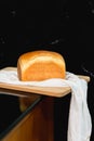 Homemade fresh white bread loaf isolated on wooden board. Royalty Free Stock Photo