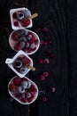 Homemade fresh yogurt. Healthy sweet dessert on dark rustic wood. Frozen fruits Royalty Free Stock Photo