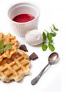 Homemade freshly baked belgian waffles with mascarpone, mint leaves and strawberry sauce isolated on white background Royalty Free Stock Photo