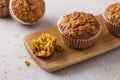 Homemade freshly baked pumpkin muffins with oatmeal and nuts on beige textured background Royalty Free Stock Photo