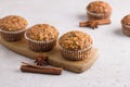 Homemade freshly baked pumpkin muffins with oatmeal and nuts on beige textured background Royalty Free Stock Photo