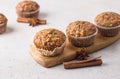 Homemade freshly baked pumpkin muffins with oatmeal and nuts on beige textured background Royalty Free Stock Photo