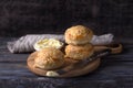 Homemade freshly baked scones with cheese and herbs on wooden board on wooden table Royalty Free Stock Photo