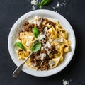 Homemade freshness pappardelle pasta with beef bolognese sauce on a dark background