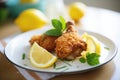 homemade fried chicken with lemon wedges Royalty Free Stock Photo