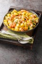 Homemade fried potatoes with garlic, herbs and shrimp close-up in a plate. Vertical Royalty Free Stock Photo