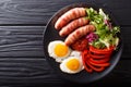 Homemade fried sausages wrapped in bacon, eggs, sauce and fresh Royalty Free Stock Photo