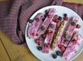 Homemade frozen yogurt bars with raspberries and blueberries. Snack for the summer days Royalty Free Stock Photo