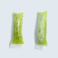 Green kiwi ice cream in vacuum plastic sticks on a gray background with copy space. Top view Royalty Free Stock Photo