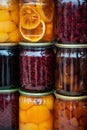 Homemade fruit preserves neatly arranged in glass jars, perfect for showcasing organic food