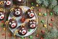 Homemade funny cupcakes Santa`s reindeers on a wooden background. Christmas idea for kids.