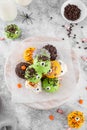 Homemade funny monster mini cakes or cake pops in a colored chocolate glaze and sugar sprinkles. Halloween treat