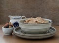 Homemade Gadola, Cereal and Nuts in Ceramic bowl served with Almond milk on wooden table