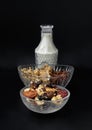 Homemade Gadola, Cereal and Nuts in Glass Bowl served with Almond Milk in Black Background
