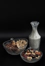 Homemade Gadola, Cereal and Nuts in Glass Bowl served with Almond Milk in Dark Background