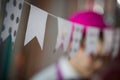 Homemade garland of paper multi-colored flags. The concept of a holiday and good mood. Toning