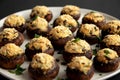 Homemade Garlic Parmesan-Stuffed Mushrooms on a plate on a black background, side view. Close-up Royalty Free Stock Photo