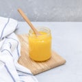 Homemade ghee clarified butter on concrete table