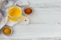 Homemade Ghee or clarified butter in a jar turmeric and paprika powder on white wooden table Royalty Free Stock Photo