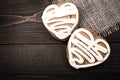 Homemade ginger cookies heart shaped over wooden table.