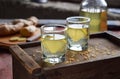 Homemade ginger tincture or ale on wooden background. Rustic style. Spice yellow liqueur in a glass. Alcohol drink. Royalty Free Stock Photo