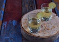 Homemade ginger tincture or ale on wooden background. Rustic style. Spice yellow liqueur in a glass. Alcohol drink. Royalty Free Stock Photo