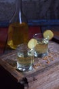 Homemade ginger tincture or ale on wooden background. Rustic style. Spice yellow liqueur in a glass. Alcohol drink. Royalty Free Stock Photo