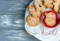 Homemade gingerbread cookies and red cup with coffee on tray on grunge gray wooden background. Christmas and New Year celebration Royalty Free Stock Photo