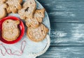 Homemade gingerbread cookies on tray with cup of coffee on grunge gray wooden table. Christmas and New Year celebration