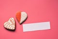 Homemade gingerbread hearts with an empty paper for your text on pink background. Valentine cookies hearts. Edible Valentine`s Da Royalty Free Stock Photo