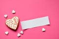 Homemade gingerbread hearts with an empty paper for your text on pink background. Valentine cookies hearts. Edible Valentine`s Da Royalty Free Stock Photo