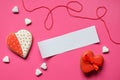 Homemade gingerbread hearts with an empty paper for your text on pink background. Valentine cookies hearts. Edible Valentine`s Da Royalty Free Stock Photo