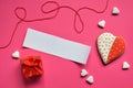 Homemade gingerbread hearts with an empty paper for your text on pink background. Valentine cookies hearts. Edible Valentines Da Royalty Free Stock Photo