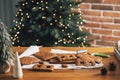 Gingerbread house on Christmas table with decorations, candles in living room Royalty Free Stock Photo