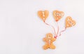 Homemade Gingerbread man with balloons in the shape of hearts with letteing I Love You on the white background. Valentines Day con