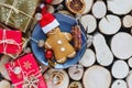 Homemade gingerbreads on plate on wooden background. Holidays and celebration concept, greeting card mockup, festive decoration