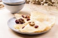 Homemade gluten free rice crepes or pancakes served with dried cranberries and walnuts Royalty Free Stock Photo
