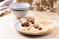 Homemade gluten free rice crepes or pancakes served with dried cranberries and walnuts Royalty Free Stock Photo