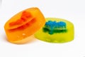 Homemade glycerin soaps for children with toys, dinosaur and rabbit inside, photographed close up on a white background. Studio