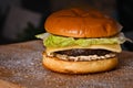 Homemade gourmet beef cheeseburger with lettuce cheese and hummus