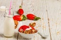 Homemade granola with fresh strawberries, yogurt and walnuts