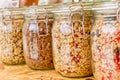Homemade granola in jar on rustic kitchen table, healthy breakfast of oatmeal muesli, nuts, seeds and dried fruit Royalty Free Stock Photo