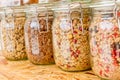 Homemade granola in jar on rustic kitchen table, healthy breakfast of oatmeal muesli, nuts, seeds and dried fruit Royalty Free Stock Photo