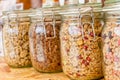 Homemade granola in jar on rustic kitchen table, healthy breakfast of oatmeal muesli, nuts, seeds and dried fruit Royalty Free Stock Photo