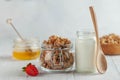 Homemade granola, milk in a jar, honey and strawberries on a wooden background. concept of a Breakfast, a healthy diet Royalty Free Stock Photo