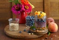 Homemade granola, muesli with blueberry and yogurt in glasses on rustic wooden background. Healthy breakfast. Royalty Free Stock Photo