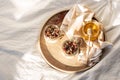 Quick healthy breakfast greek yogurt, honey, granola with dried berries and nuts in glass jar on wooden tray on white bedding Royalty Free Stock Photo