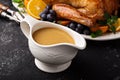 Homemade gravy in a sauce dish with turkey