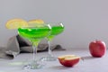 Homemade green apple martini cocktail with apple pieces in glasses Royalty Free Stock Photo